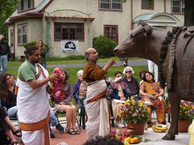T.R. Sampathkumar of Epping, N.H., and T.L. Krishnabhatta of Ashland, left, bless the statue of Emily the Cow Sunday at the Sherborn Peace Abbey.