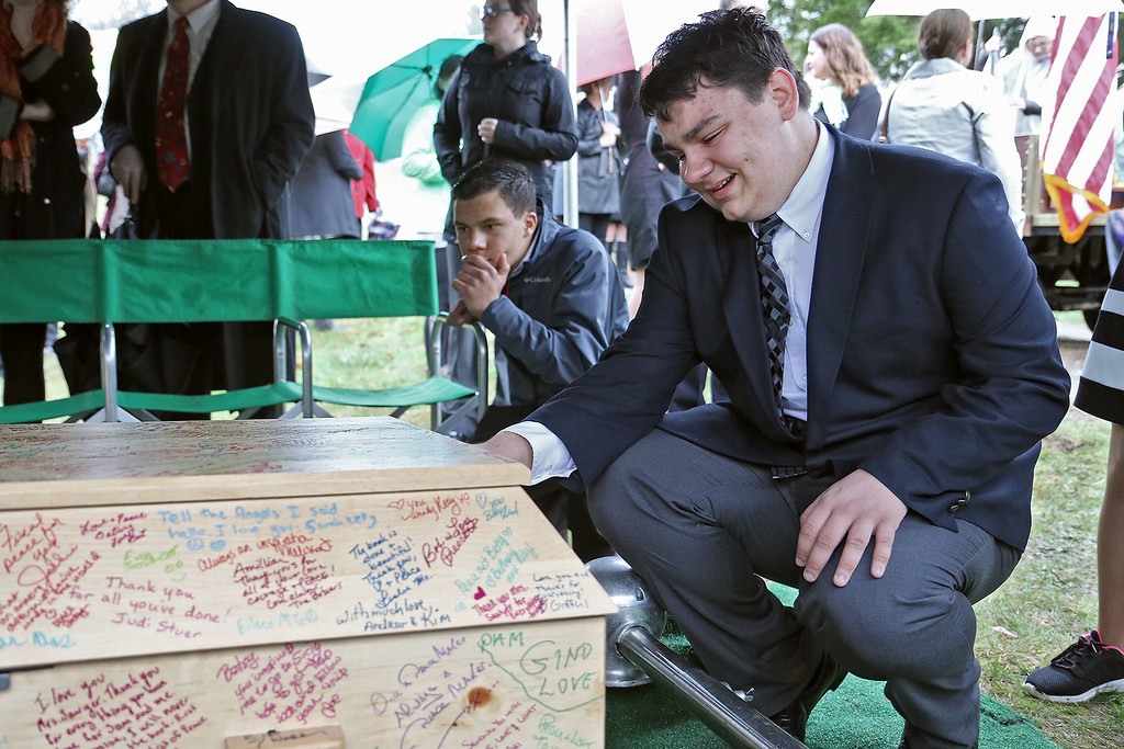 Michael Suchecki, 17, a Junior at Groton Dunstble High School and a member of the Bookmakers and Dreamers club got a little emotional as he said good by to Rosemary E. "Betsy" Sawyer on Tuesday morning at her funeral in Shirley. Sawyer was the teacher that started the Bookmakers and Dreamers after school program in 2004. SENTINEL & ENTERPRISE/JOHN LOVE