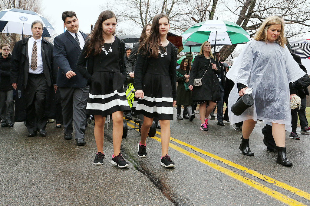 A funeral was held for Rosemary E. "Betsy" Sawyer on Tuesday morning in Shirley. After a ceremony at the Bull Run her casket was loaded onto a caisson and pushed up to Center Cemetery in Shirley for burial. waling just in front of the caisson is twins Jill and Kate Suchecki, 12, seventh graders at Groton Dunstable Middle School who where members of Sawyers Bookmakers and Dreamers Club. SENTINEL & ENTERPRISE/JOHN LOVE